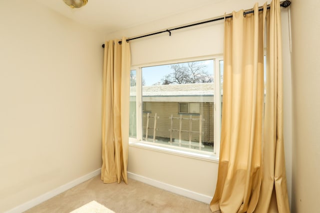 carpeted empty room with baseboards