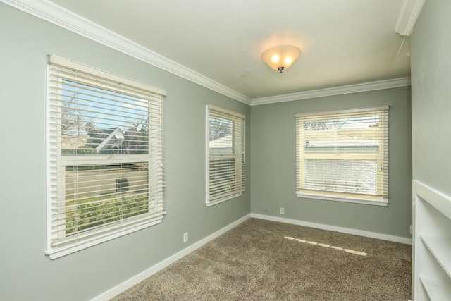 carpeted empty room with crown molding and baseboards