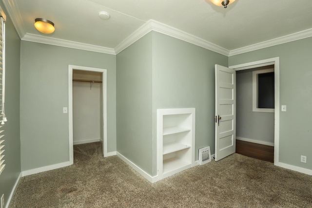 unfurnished bedroom featuring visible vents, baseboards, ornamental molding, a closet, and carpet