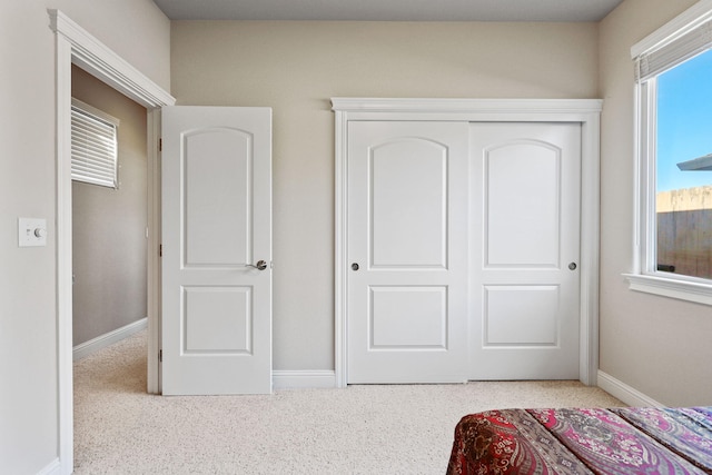 bedroom featuring carpet floors, baseboards, and a closet