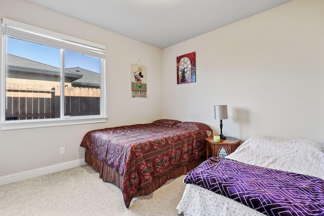 carpeted bedroom featuring baseboards