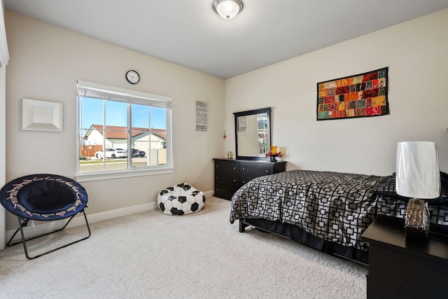 bedroom featuring carpet floors and baseboards