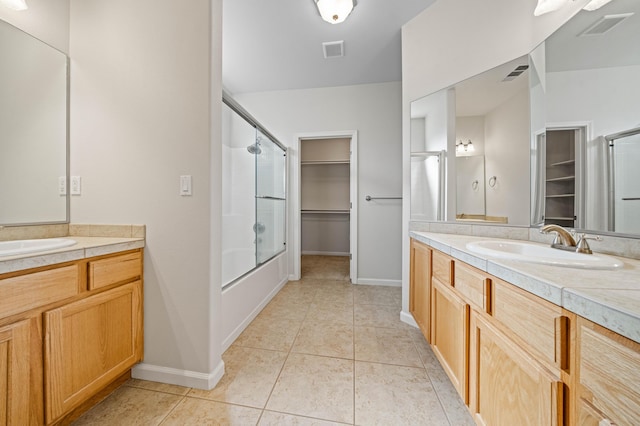 bathroom featuring tile patterned flooring, visible vents, and a sink