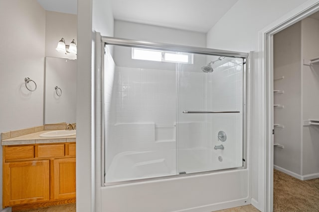 bathroom with vanity and bath / shower combo with glass door