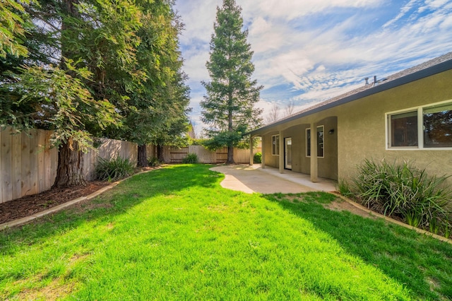 view of yard featuring a patio and a fenced backyard