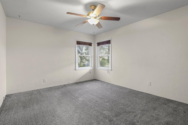 spare room featuring carpet, ceiling fan, a textured ceiling, and a textured wall