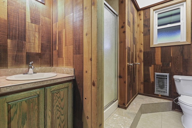 full bathroom featuring wooden walls, toilet, heating unit, vanity, and a shower stall