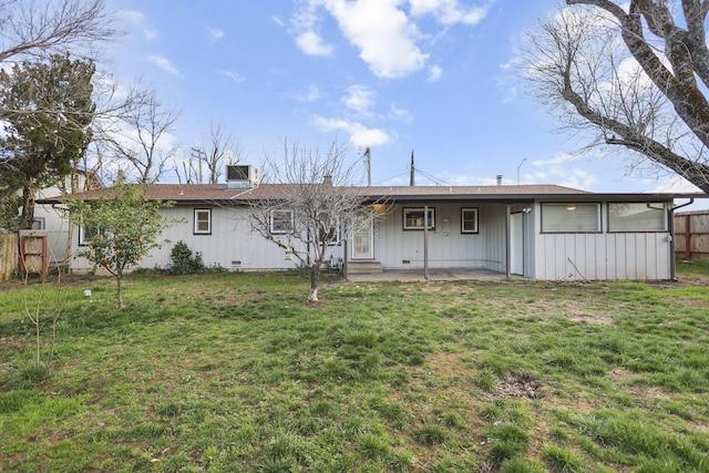 rear view of house with a patio area, fence, and a lawn