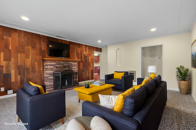 carpeted living room with baseboards, wood walls, a brick fireplace, and recessed lighting