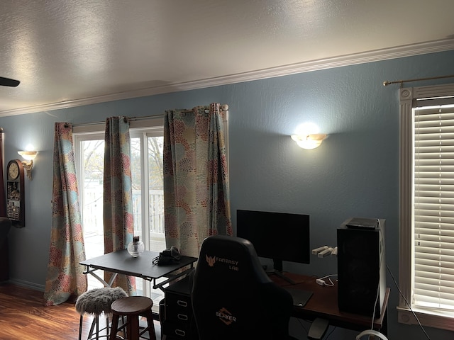 office area with ornamental molding, a textured wall, and wood finished floors