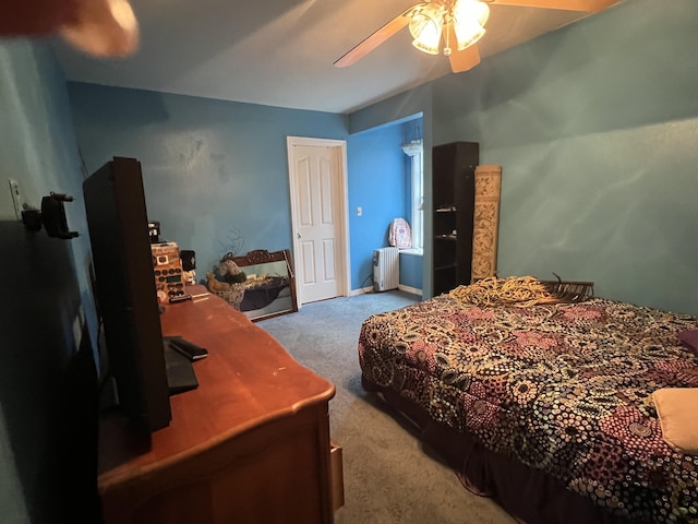 carpeted bedroom featuring ceiling fan and radiator