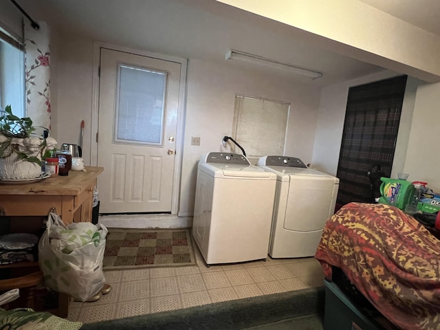 washroom featuring light floors, laundry area, and independent washer and dryer