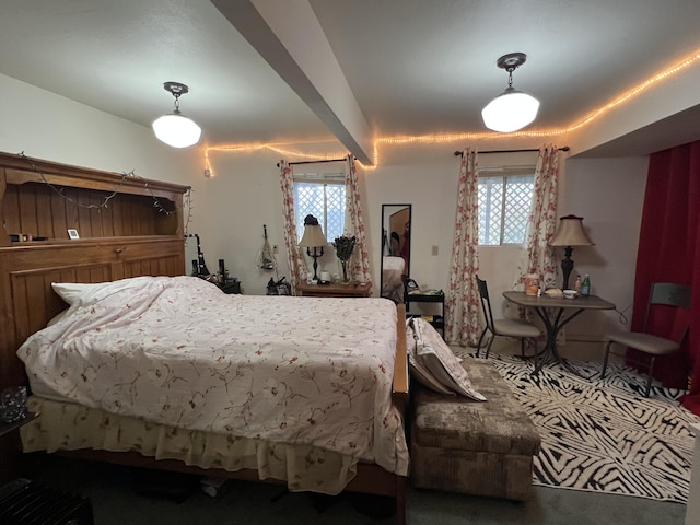 carpeted bedroom featuring multiple windows