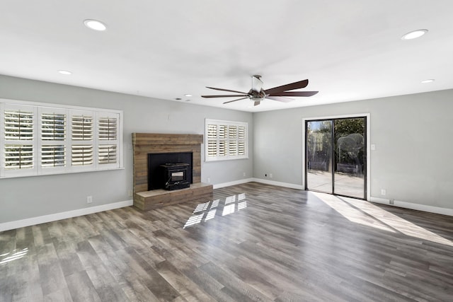 unfurnished living room featuring wood finished floors and baseboards