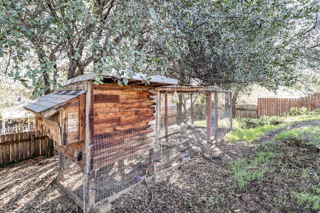 view of poultry coop featuring fence