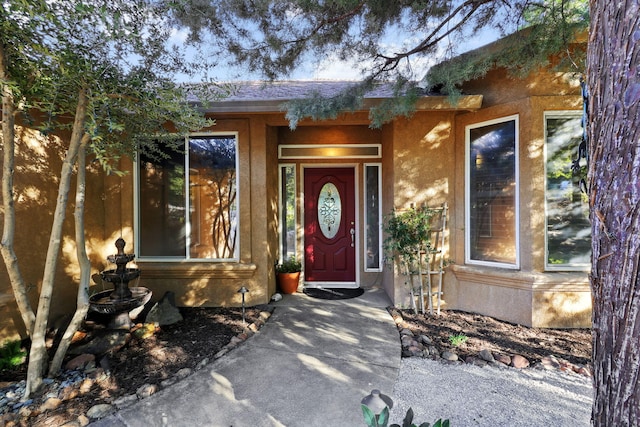 entrance to property with stucco siding