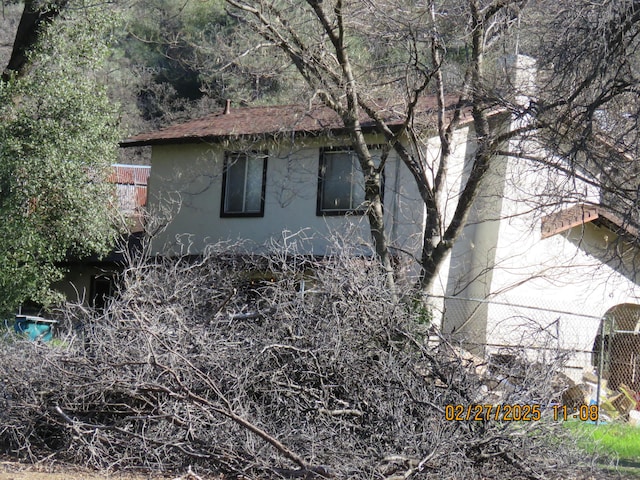 view of home's exterior featuring fence