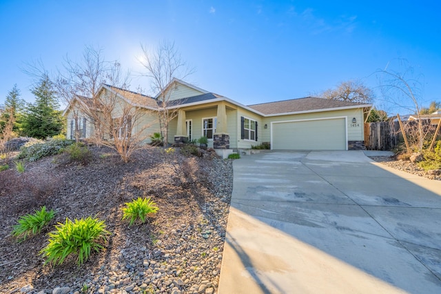 view of front of house with driveway, a garage, and fence