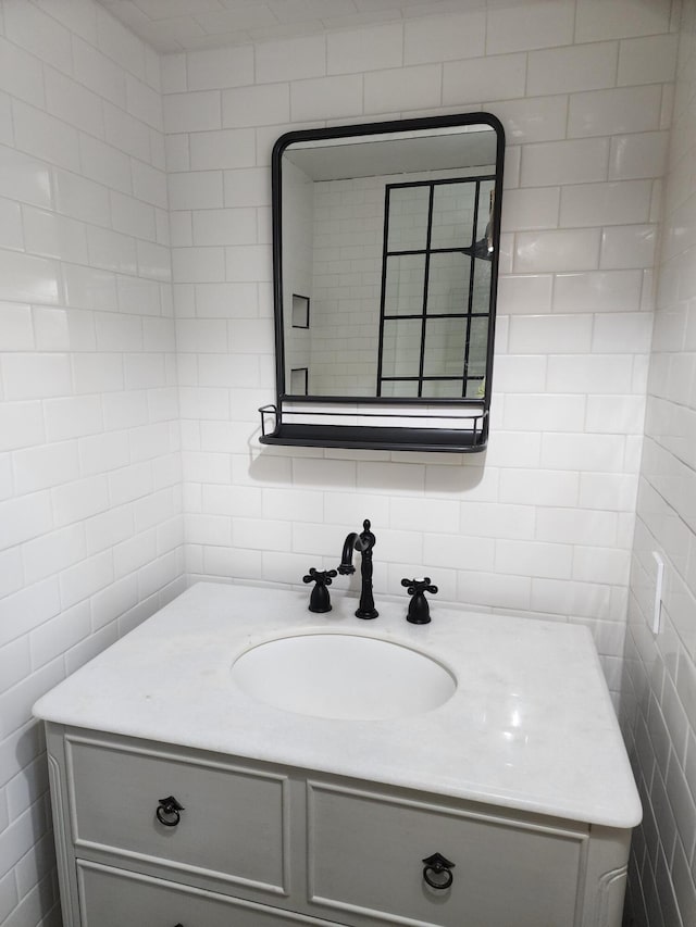 bathroom with tile walls and vanity