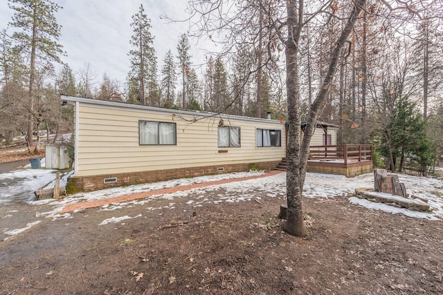 manufactured / mobile home featuring crawl space and a deck