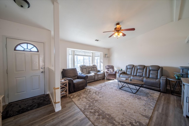 living room with dark wood finished floors, visible vents, and ceiling fan