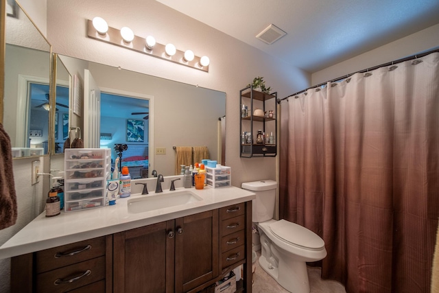 ensuite bathroom featuring vanity, toilet, visible vents, and connected bathroom