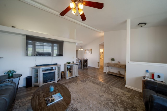 living area featuring a ceiling fan, wood finished floors, baseboards, lofted ceiling, and a fireplace