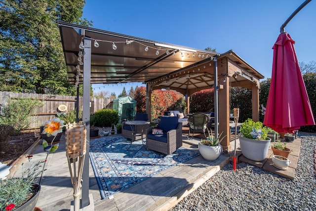 view of patio / terrace with a gazebo, fence, and an outdoor hangout area