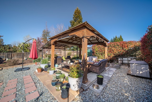 view of patio featuring a gazebo, a fenced backyard, and an outdoor living space