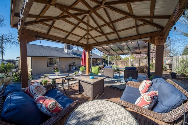 view of patio with a gazebo, outdoor dining area, an outdoor hangout area, and fence