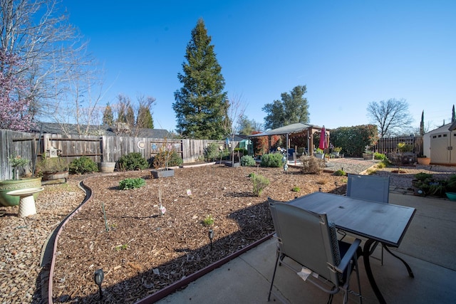 view of yard with a patio area, outdoor dining area, and a fenced backyard