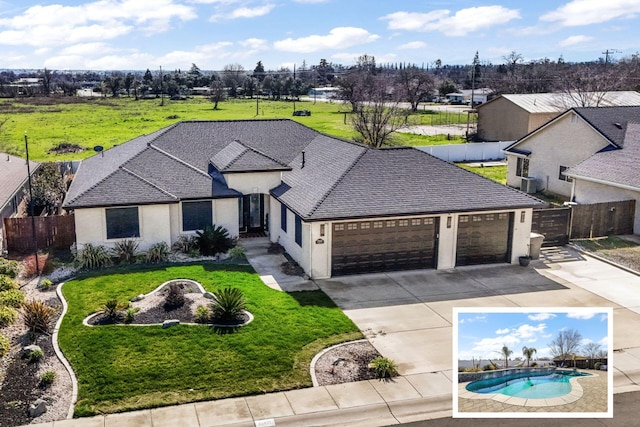 view of front of house with stucco siding, an attached garage, concrete driveway, and fence