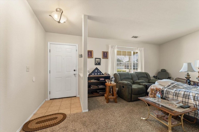 living area with light tile patterned floors, baseboards, visible vents, and light colored carpet