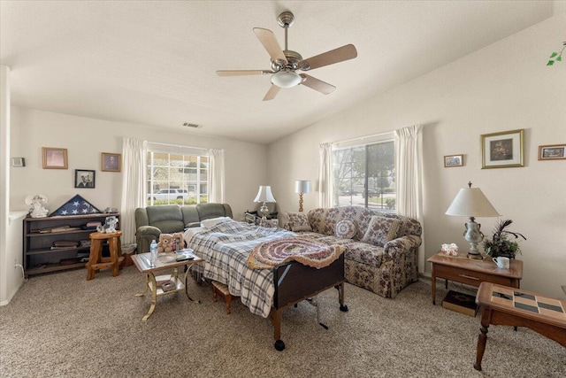 bedroom with visible vents, a ceiling fan, vaulted ceiling, and carpet flooring