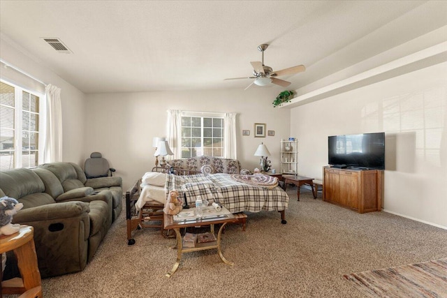 carpeted living room with vaulted ceiling, visible vents, ceiling fan, and baseboards