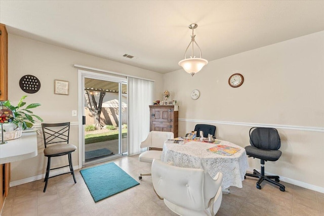 dining space featuring baseboards and visible vents