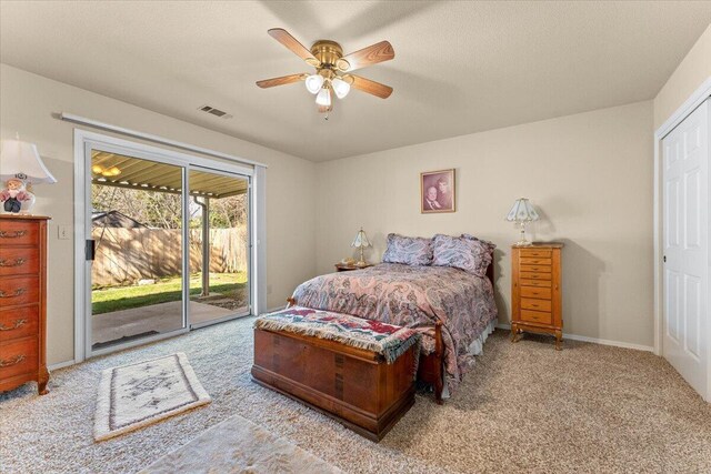 carpeted bedroom with baseboards, access to outside, visible vents, and a ceiling fan