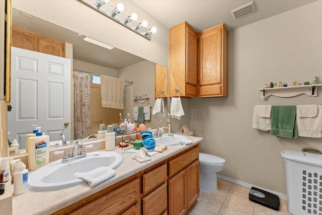 full bath with a shower with curtain, visible vents, toilet, a sink, and tile patterned flooring