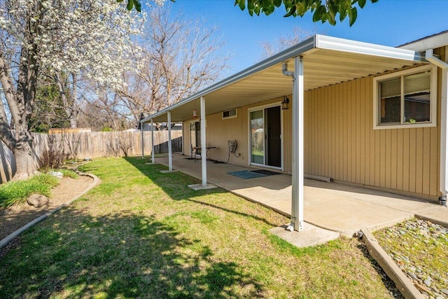 view of yard with fence and a patio