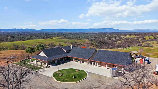 bird's eye view with a mountain view and a view of trees