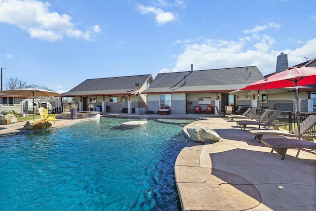 pool featuring a patio area and fence