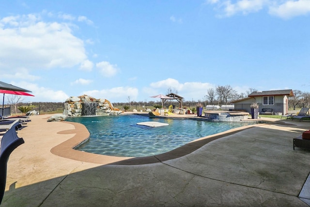 view of swimming pool featuring a patio area, fence, and a pool with connected hot tub