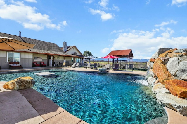 view of swimming pool featuring a patio area, fence, and a fenced in pool