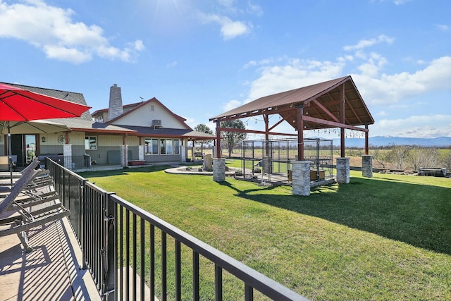 surrounding community featuring fence, a lawn, and a gazebo