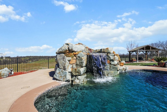 view of swimming pool with fence, a patio, and a gazebo