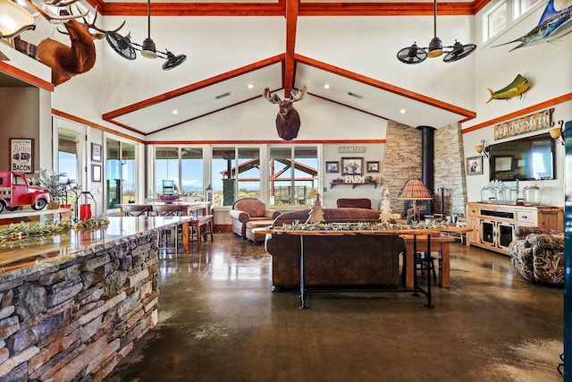 living room featuring beam ceiling, visible vents, finished concrete floors, a wood stove, and high vaulted ceiling