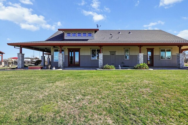 rear view of property featuring a yard