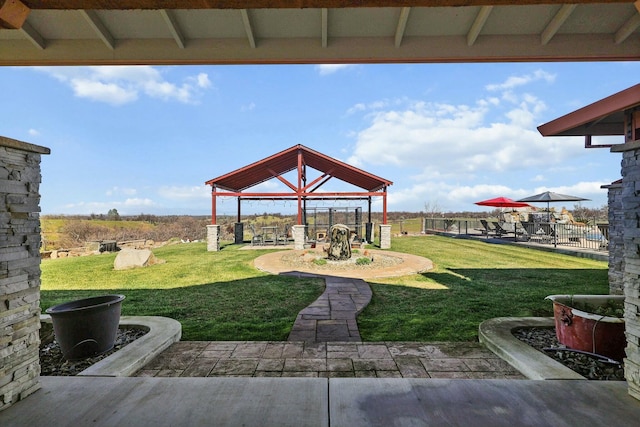 view of yard with a patio area, fence, and a gazebo