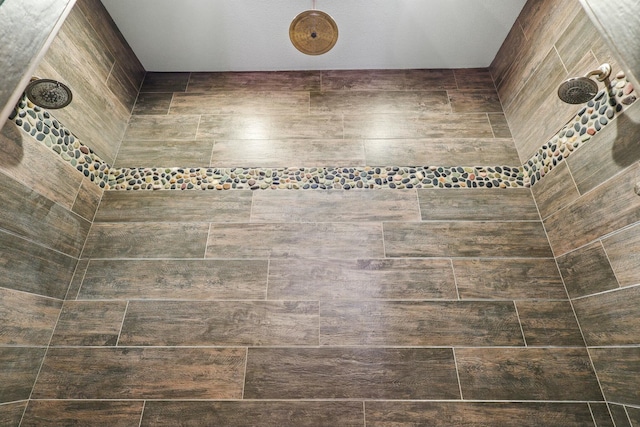 interior details with a tile shower