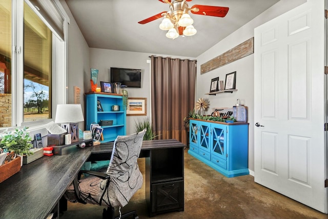 office area with concrete flooring and a ceiling fan